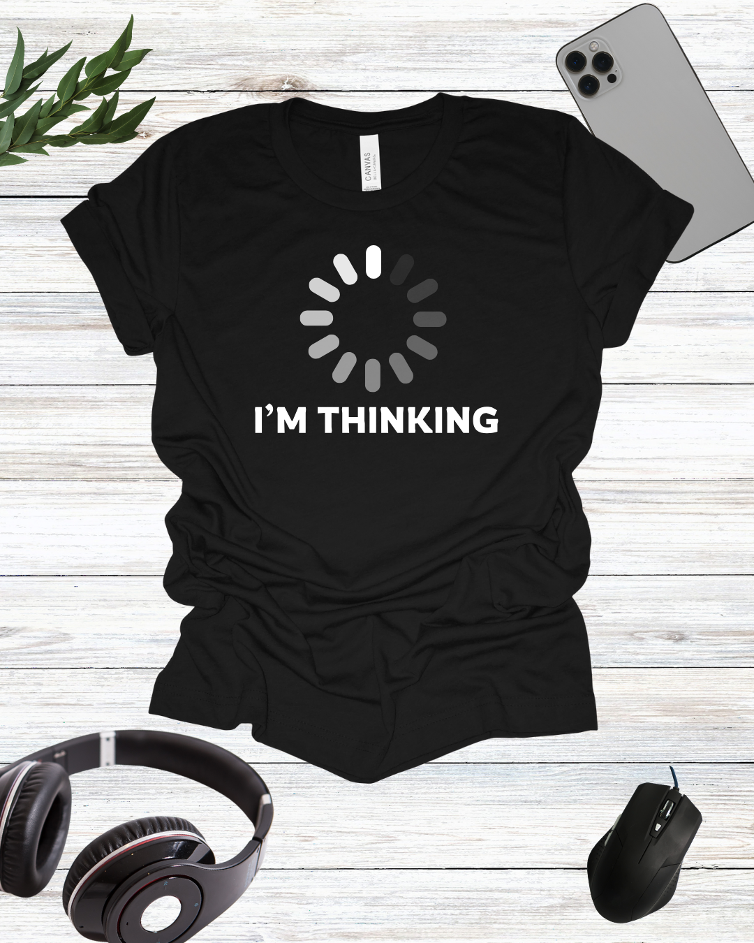 a t - shirt that says i'm thinking next to headphones and a