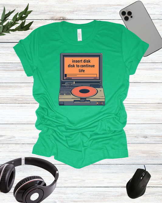 a t - shirt with a picture of a laptop and headphones