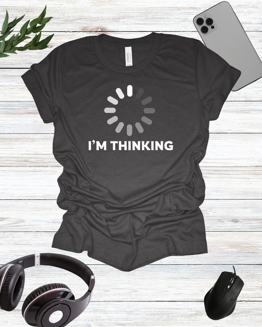 a t - shirt that says i'm thinking next to headphones and a