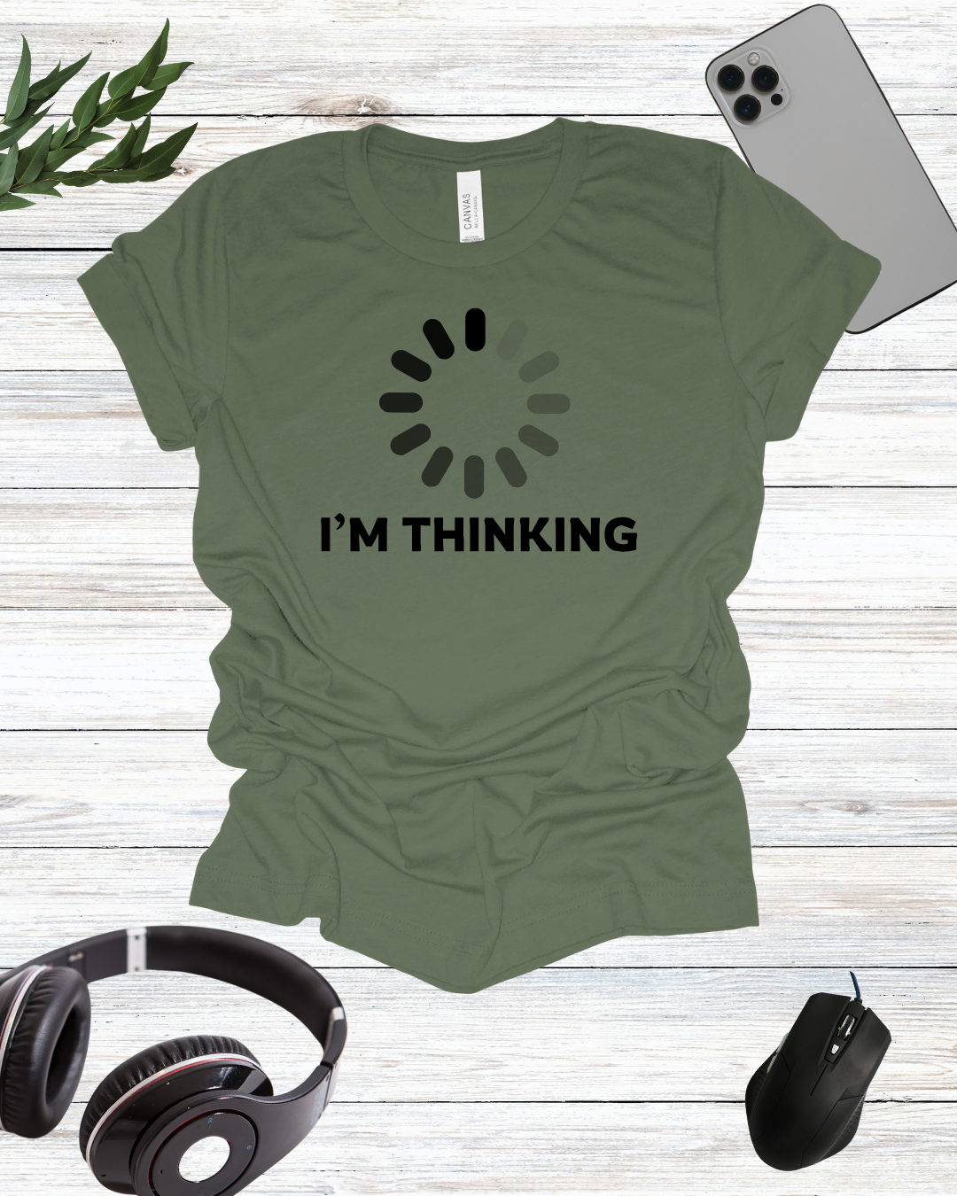 a t - shirt that says i'm thinking next to headphones and a