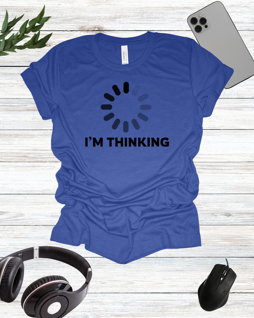 a t - shirt that says i'm thinking next to headphones and a