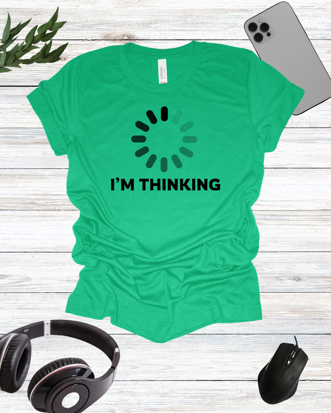 a t - shirt that says i'm thinking next to headphones and a