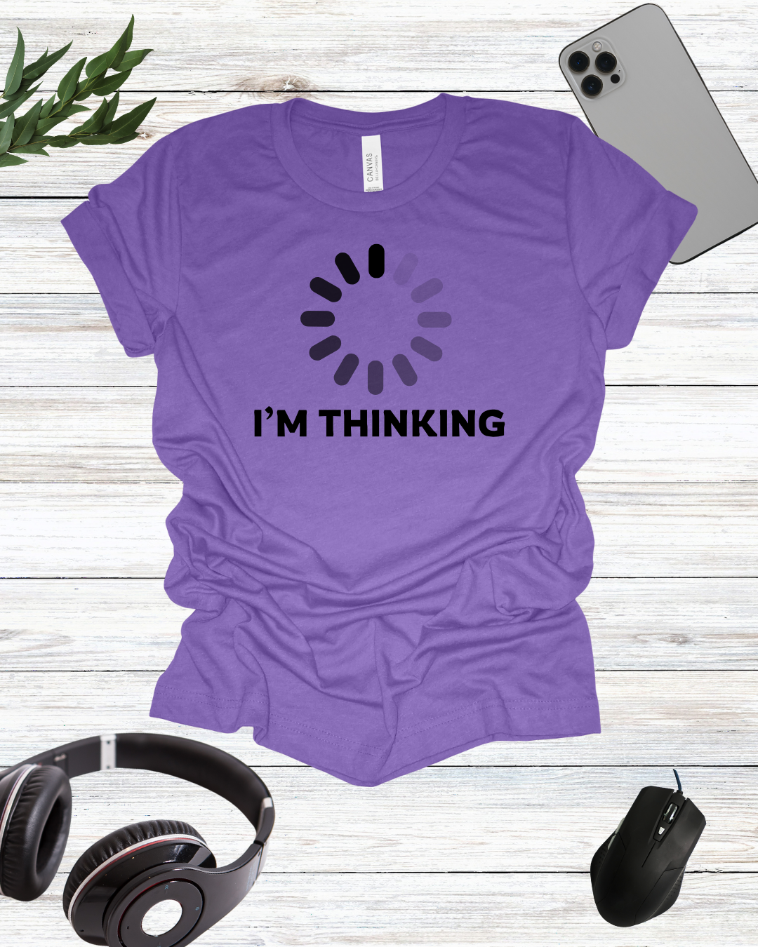 a t - shirt that says i'm thinking next to headphones and a